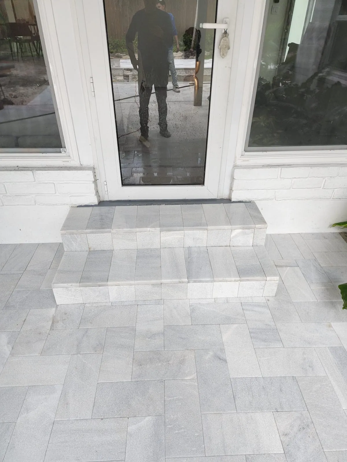 Gray stone steps at a glass door
